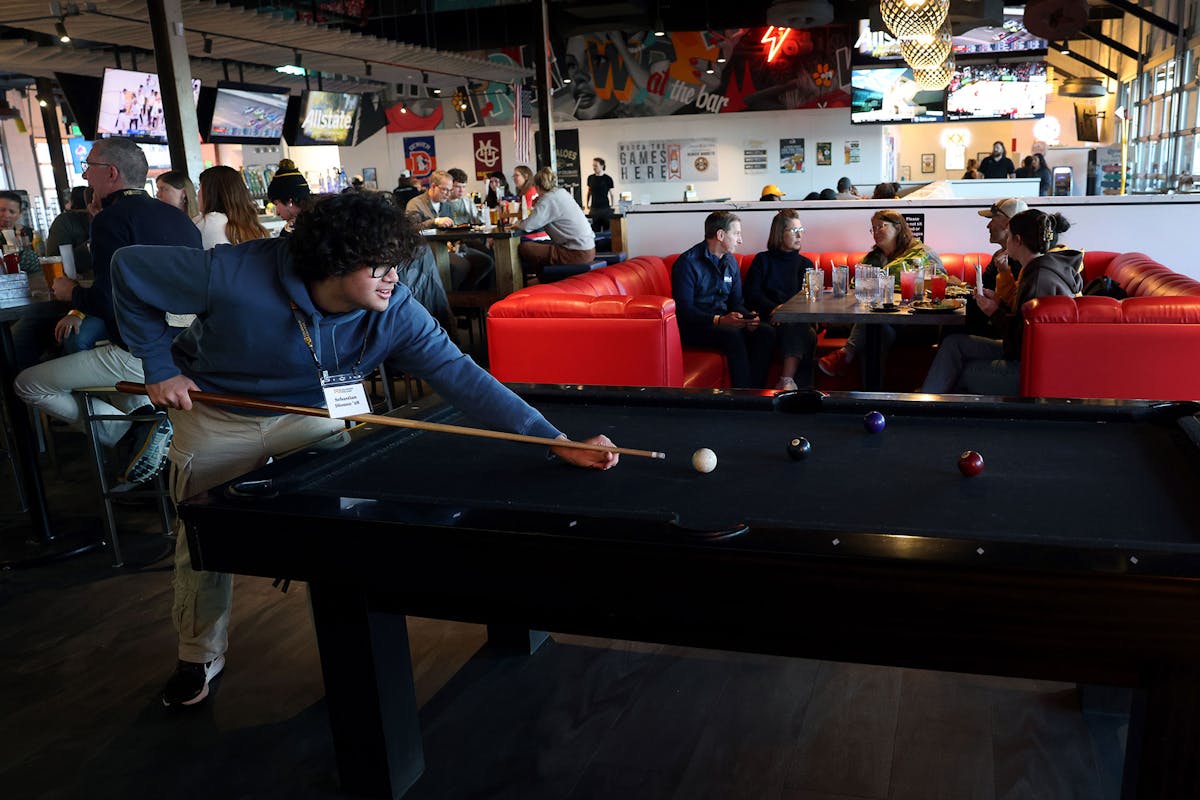 Sebastian Dionne '28 plays pool with family members during Family Weekend on Feb. 22 at Train Wreck Bar and Grill downtown. Photo by Jamie Cotten / Colorado College