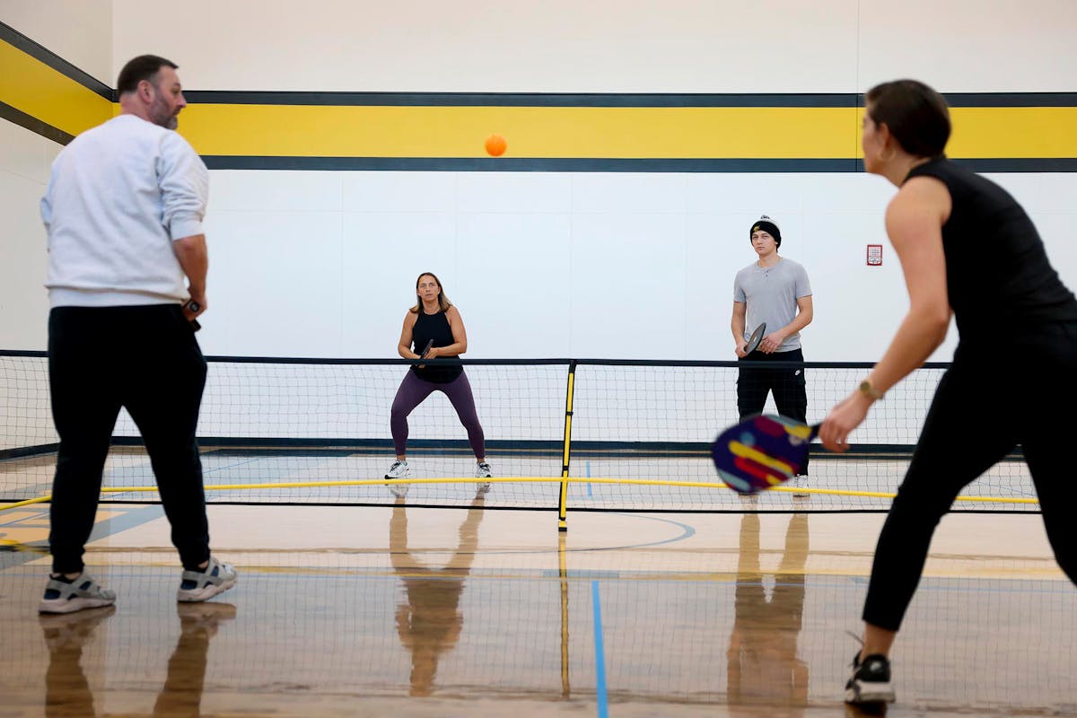 Marta Kaminksi, center left, and her son Dominik Kaminski '27, center right, play a competitive game of pickleball on Feb. 22 during Family Weekend on the court at El Pomar. Photo by Jamie Cotten / Colorado College