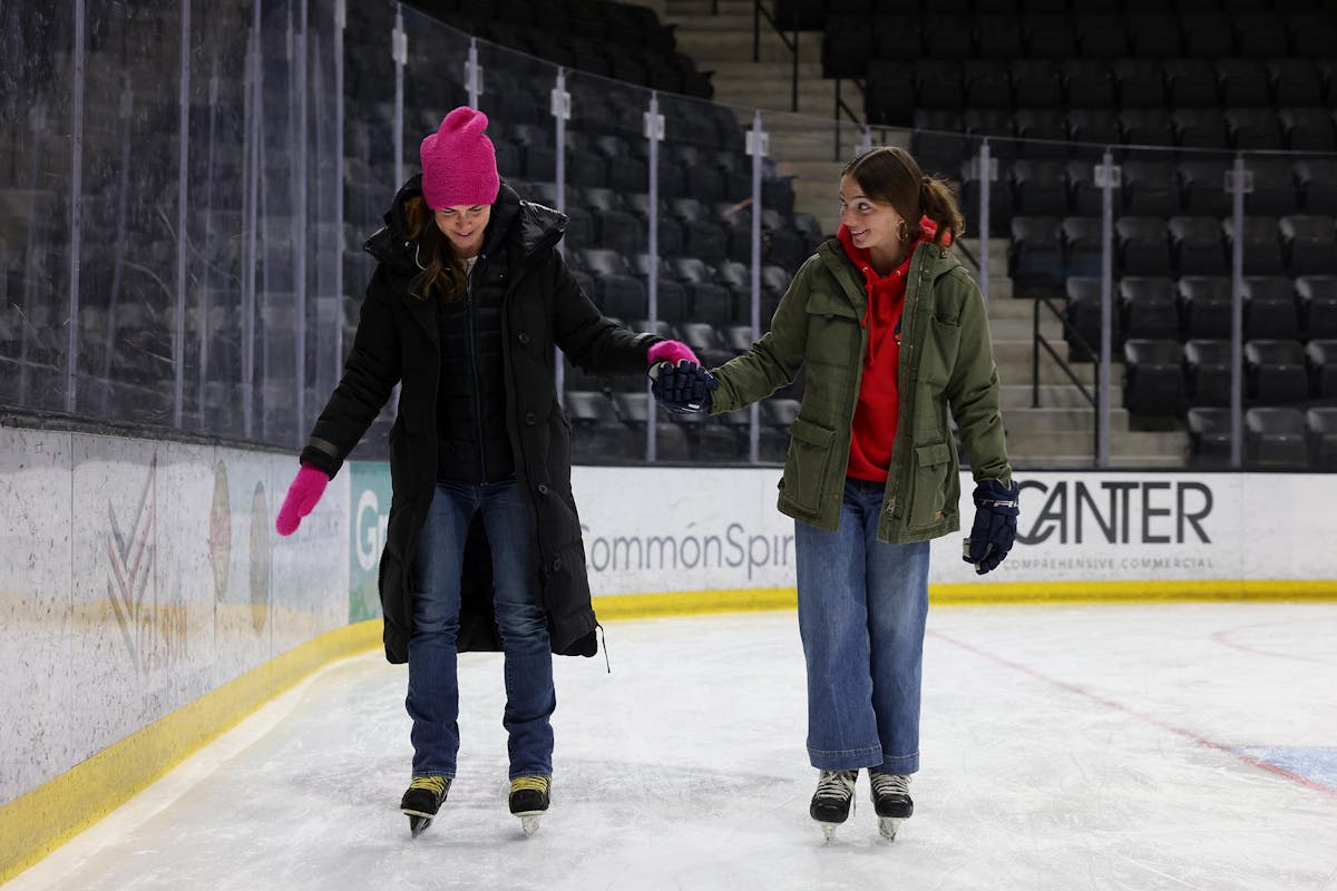 Ali Simanson, left, gets some loving support and tips from her daughter, Gray Simanson '28 (a natural on the ice who plays hockey) during the Family Weekend farewell brunch and open skate on Feb. 23 at Robson Arena. Photo by Jamie Cotten / Colorado College