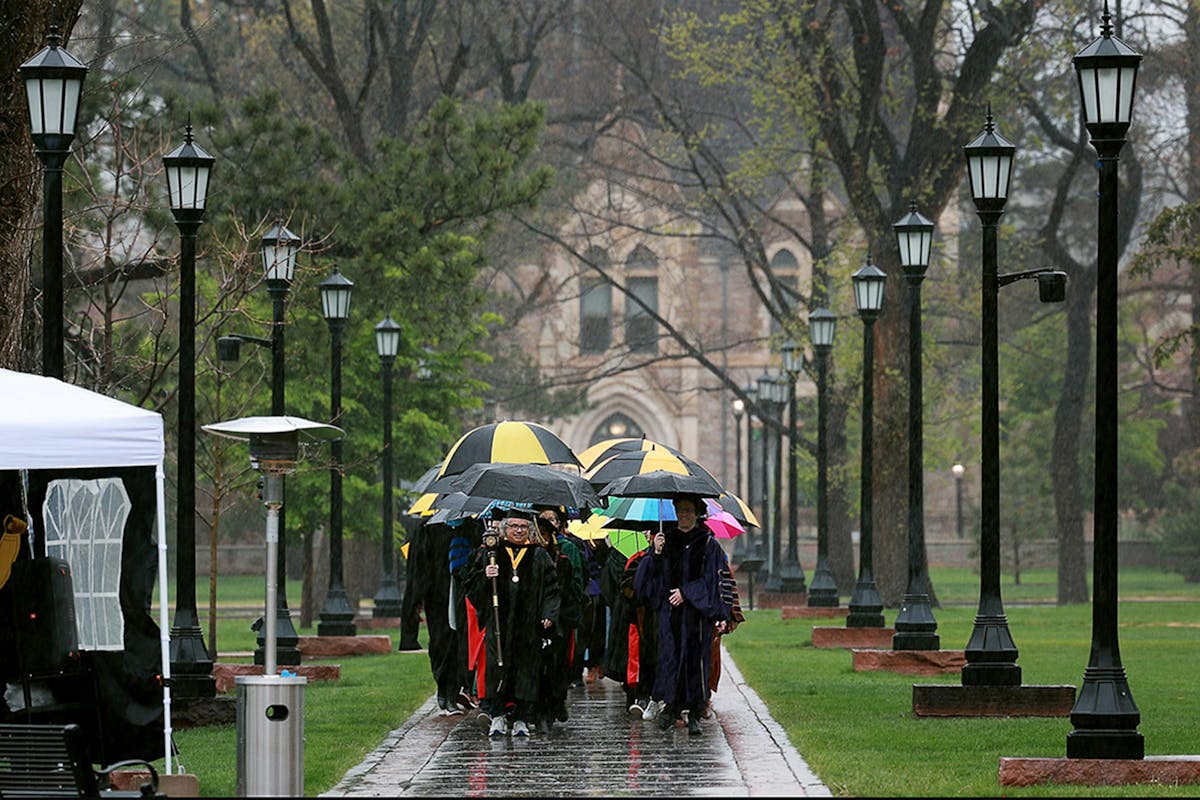 The Honors Convocation processional involved faculty and staff walking in the rain on May 6 to Shove Chapel. Photo by Jamie Cotten / Colorado College