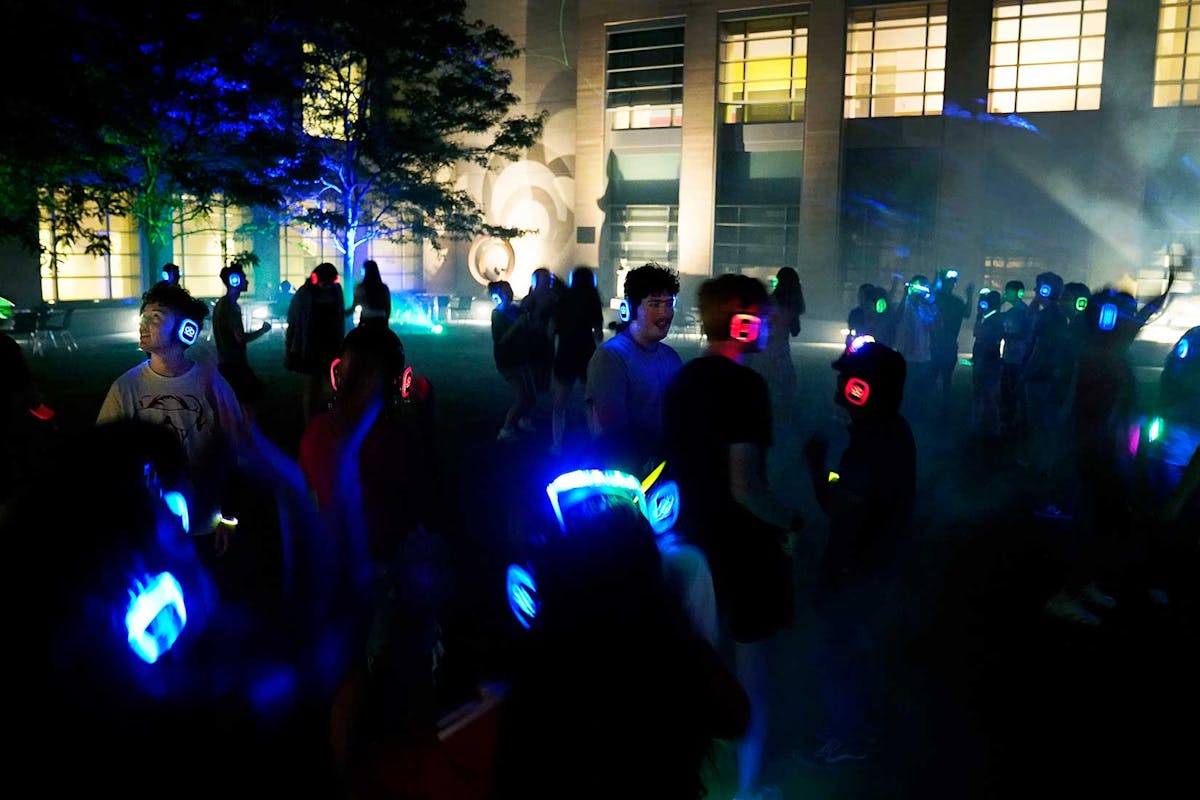 Incoming first-year students rock out on August 23 during a silent disco in the courtyard at the FAC. Photo by Jamie Cotten