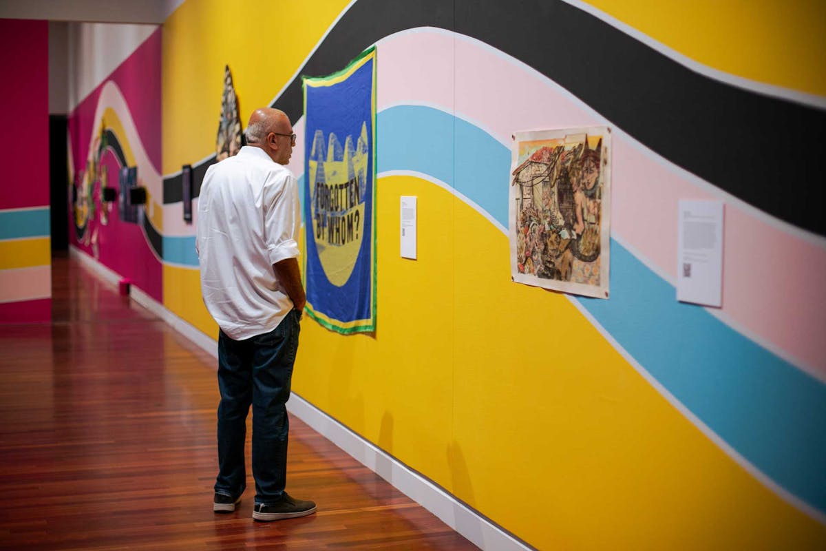 A patron observes a piece of art at the opening of ALHAMDU | MUSLIM FUTURISM at the FAC, Friday, Sept. 13. Photo by Parker Seibold