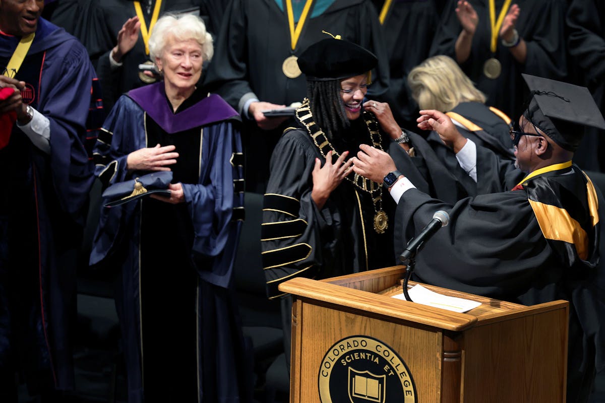 Former CC Pres. Kathryn Mohrman looks on as Pres. Dr. Manya Whitaker is bestowed with the "Chain of Office" by Board of Trustees Chair Kyle Samuel '92. Photo by Jamie Cotten / Colorado College 