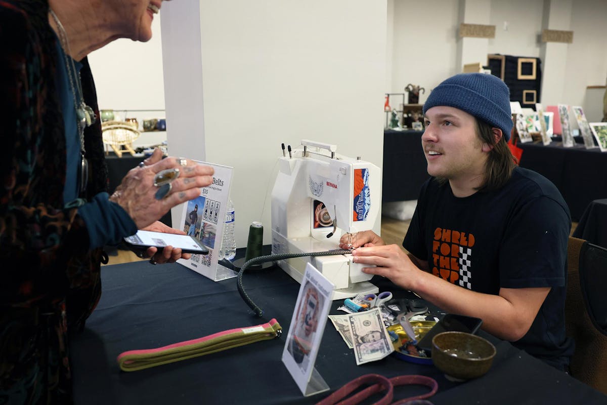 Pierson Parker '28, who learned to sew from his grandmother, sells belts to order on Dec. 5 at Worner during the annual Arts & Crafts festival. Photo by Jamie Cotten / Colorado College