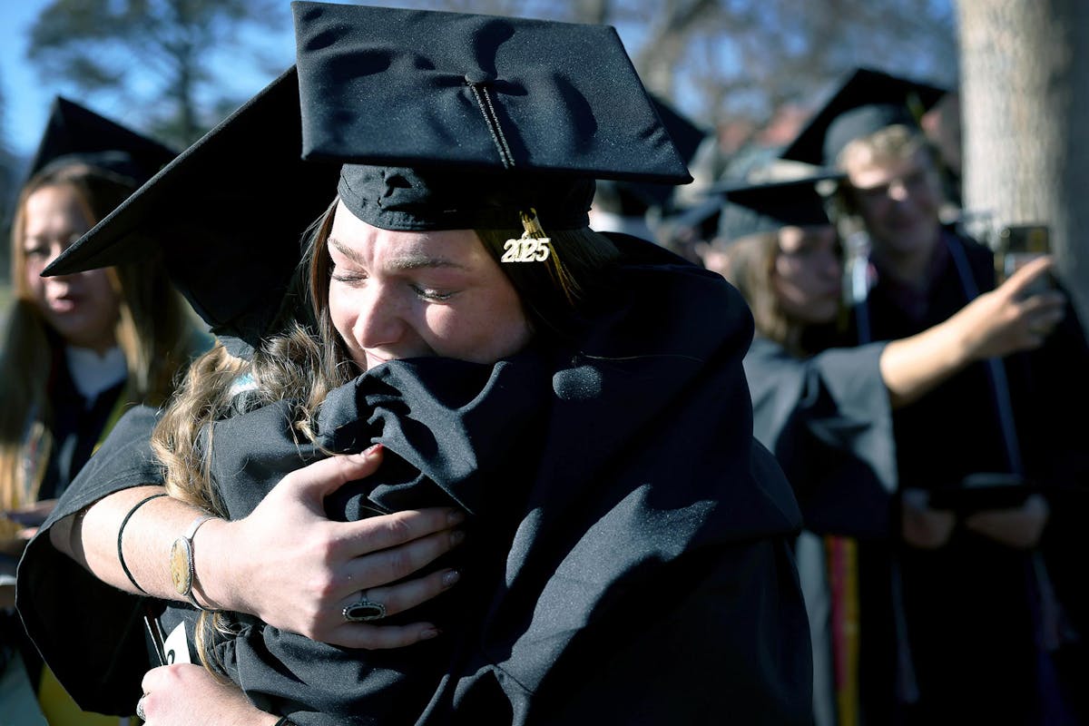 Ryan Maguire '26, hugs a friend and fellow graduate on Dec. 14 after Winter Commencement 2025. Photo by Jamie Cotten / Colorado College