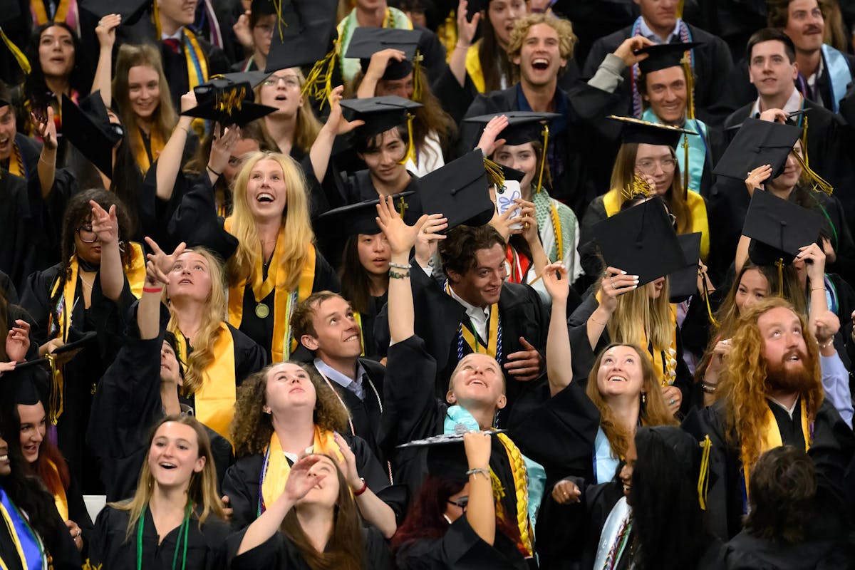 New graduates celebrate with a hat toss at the conclusion of Commencement on May 18 at Robson Arena. Photo by Mark Reis for Colorado College