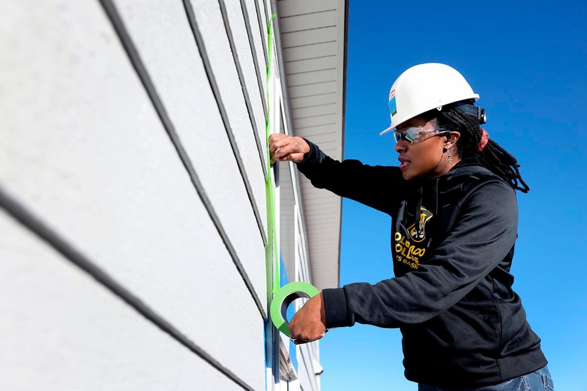  Interim Pres. Dr. Manya Whitaker volunteers during "Week of Action" at Habitat for Humanity at a housing development. Photo by Jamie Cotten / Colorado College