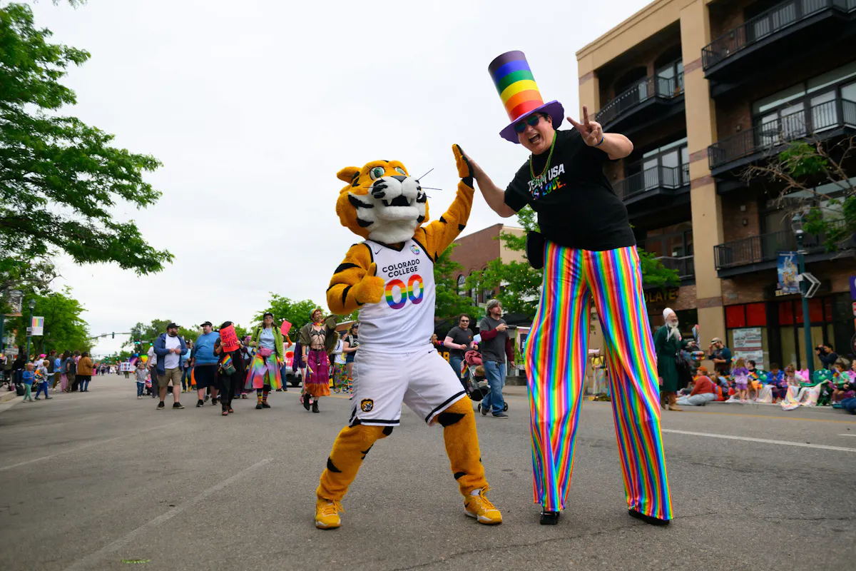 RoCCy high-fiving a stilt walker as CC participated in the Pikes Peak Pride Parade on Sunday, June 14. Photos by Mark Reis / Colorado College