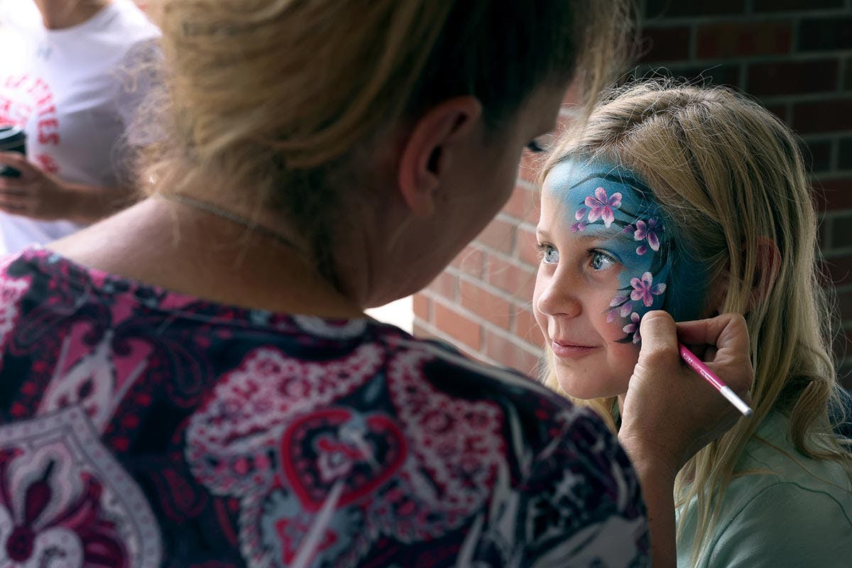 A young girl gets her face painted at CC Day on Tuesday, Jul. 22. Photo by Jamie Cotten.