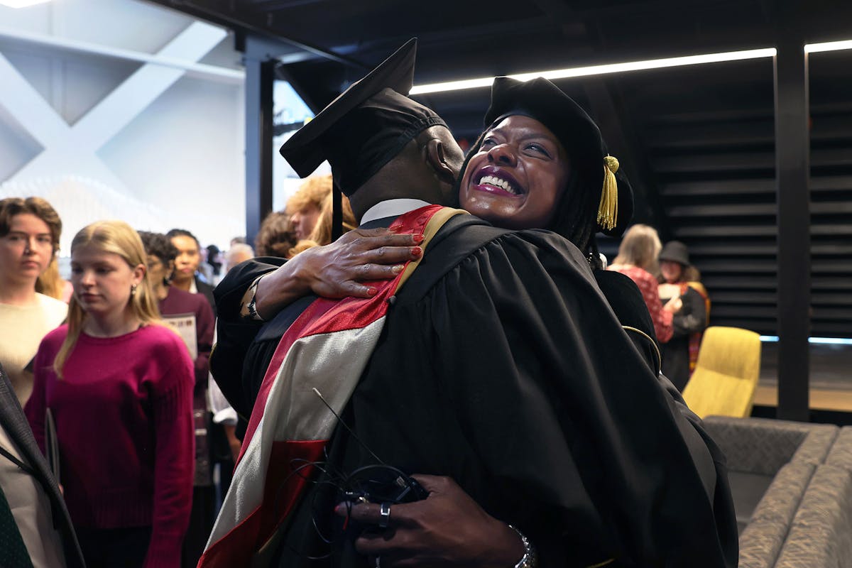 Pres. Dr. Manya Whitaker hugs a colleague and Board of Trustees member on Nov. 8 at Robson during her presidential inauguration. Photo by Jamie Cotten / Colorado College