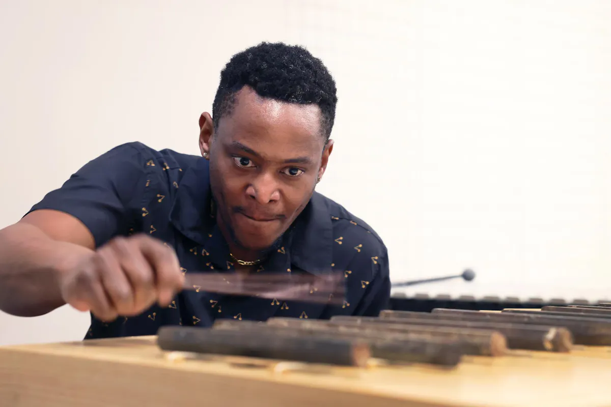 Renowned Chicago musician Thaddeus Tukes played a variety of percussive instruments, including artist Maria Gaspar’s sonic sculpture made of iron bars salvaged from that demolition, at an interdisciplinary exhibit on Feb. 27 at the FAC. Photo by Jamie Cotten / Colorado College