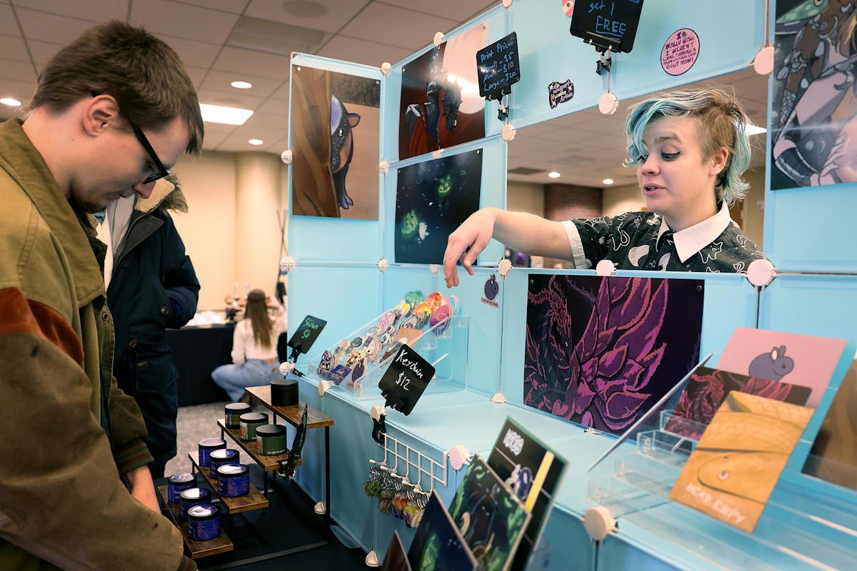 Lin Okonek, Project Management and Outreach Coordinator for ITS, sells their art and hand-crafted candles at the CC Arts & Craft fair, Dec. 5 and 6. Photo by Jamie Cotten